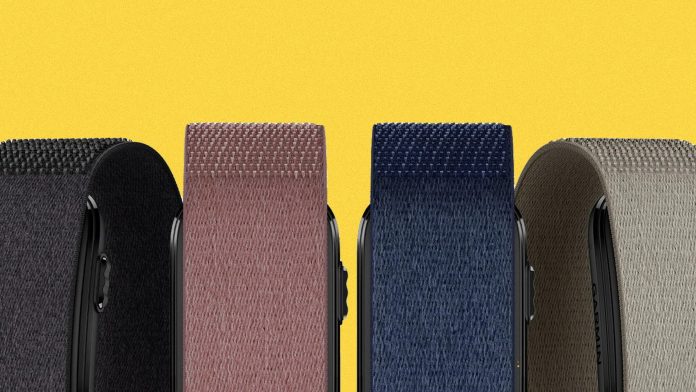 Four woven fabric smartwatch bands in black, mauve, navy blue, and gray colors against a yellow background.