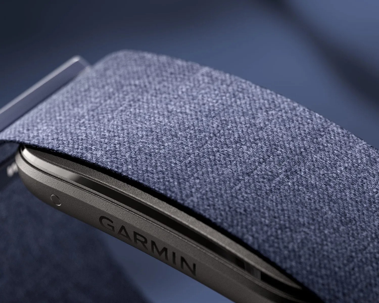 Close-up of a Garmin device with a textured blue fabric strap.